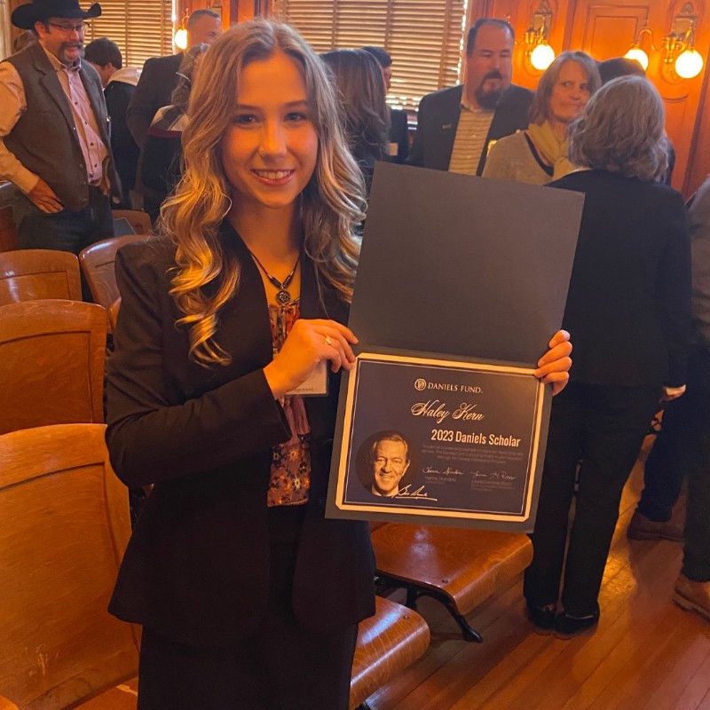 Hailey, holding up her award certificate